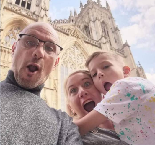 Family of three in front of a church