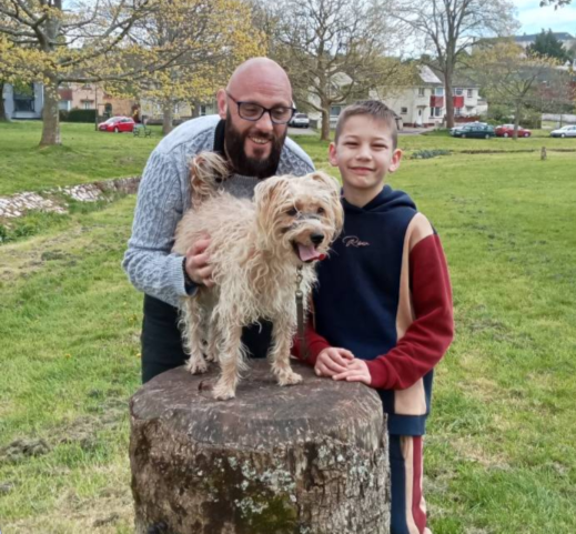 Father and son with a cute dog