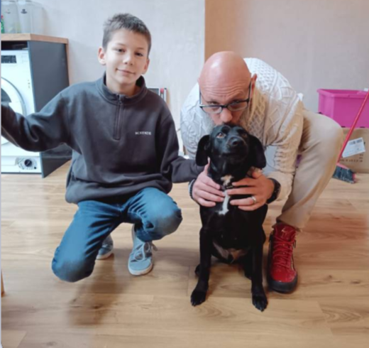 Father and son with a pet sit dog